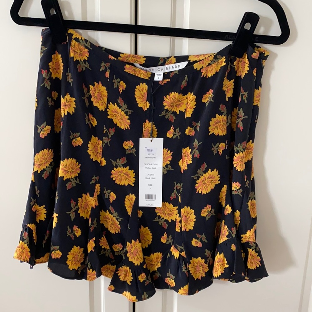 Black and yellow flowered pleated skirt.